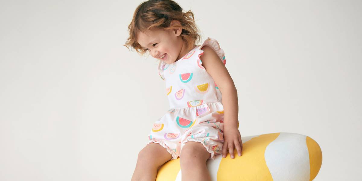 Baby girl wearing fruit-patterned romper